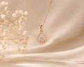 Rose gold teardrop crystal pendant necklace by Couturier Design, elegant minimal jewelry for women, featuring a sparkling crystal drop.
