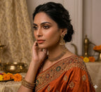 Antique gold jhumka earrings with small dangling beads, worn in side profile