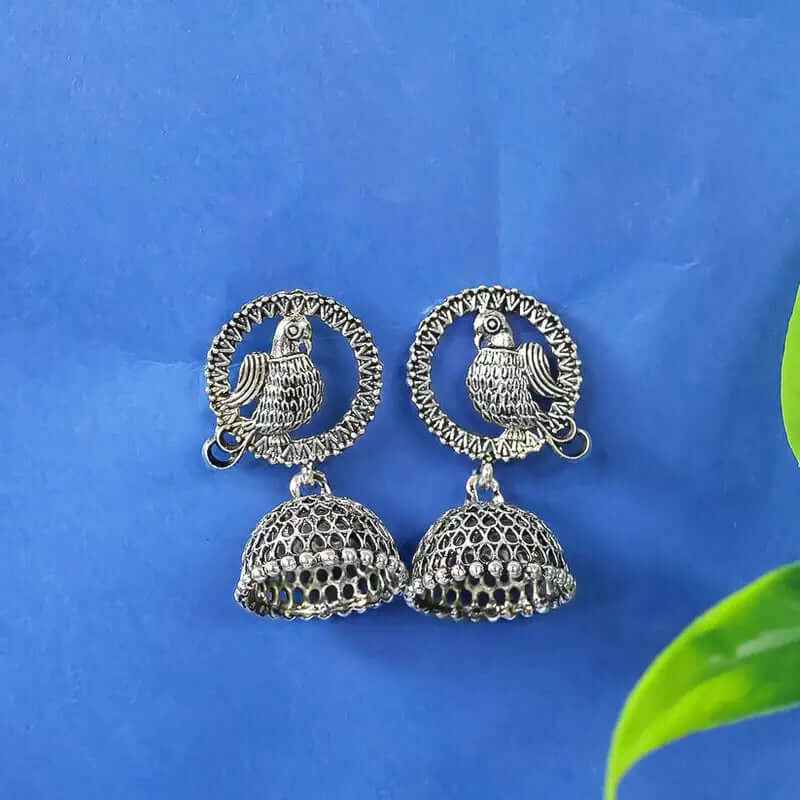 Oxidised silver peacock jhumka earrings with two-tier bell dangle and circular motif