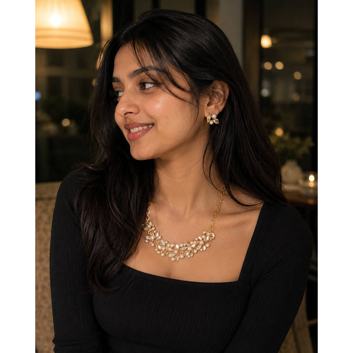 Gold-pearl floral choker necklace and small stud earrings on a woman