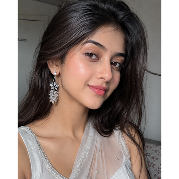 Floral crystal drop earrings with dangling clear stones on a silver-tone