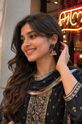 Jhumka earrings with black meenakari, pearl drops, and gold-tone detailing