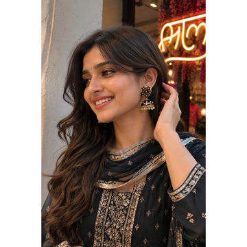 Jhumka earrings on wearer: black bell with gold trim and multicolor