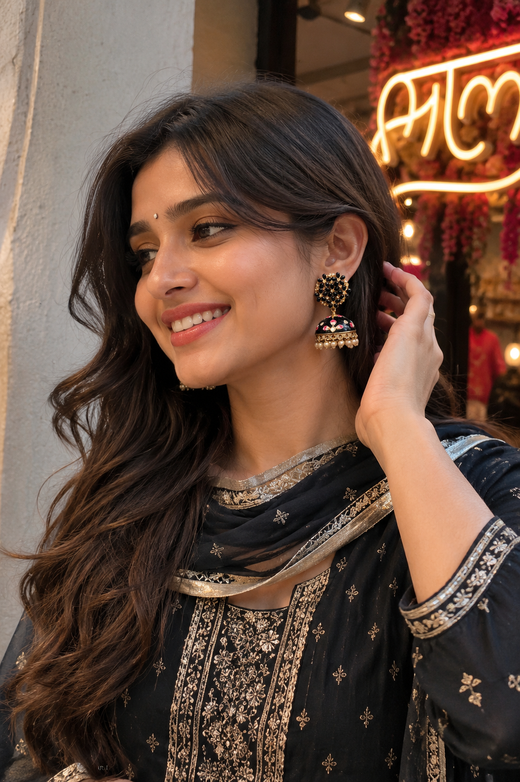 Jhumka earrings with black meenakari, pearl drops, and gold-tone detailing