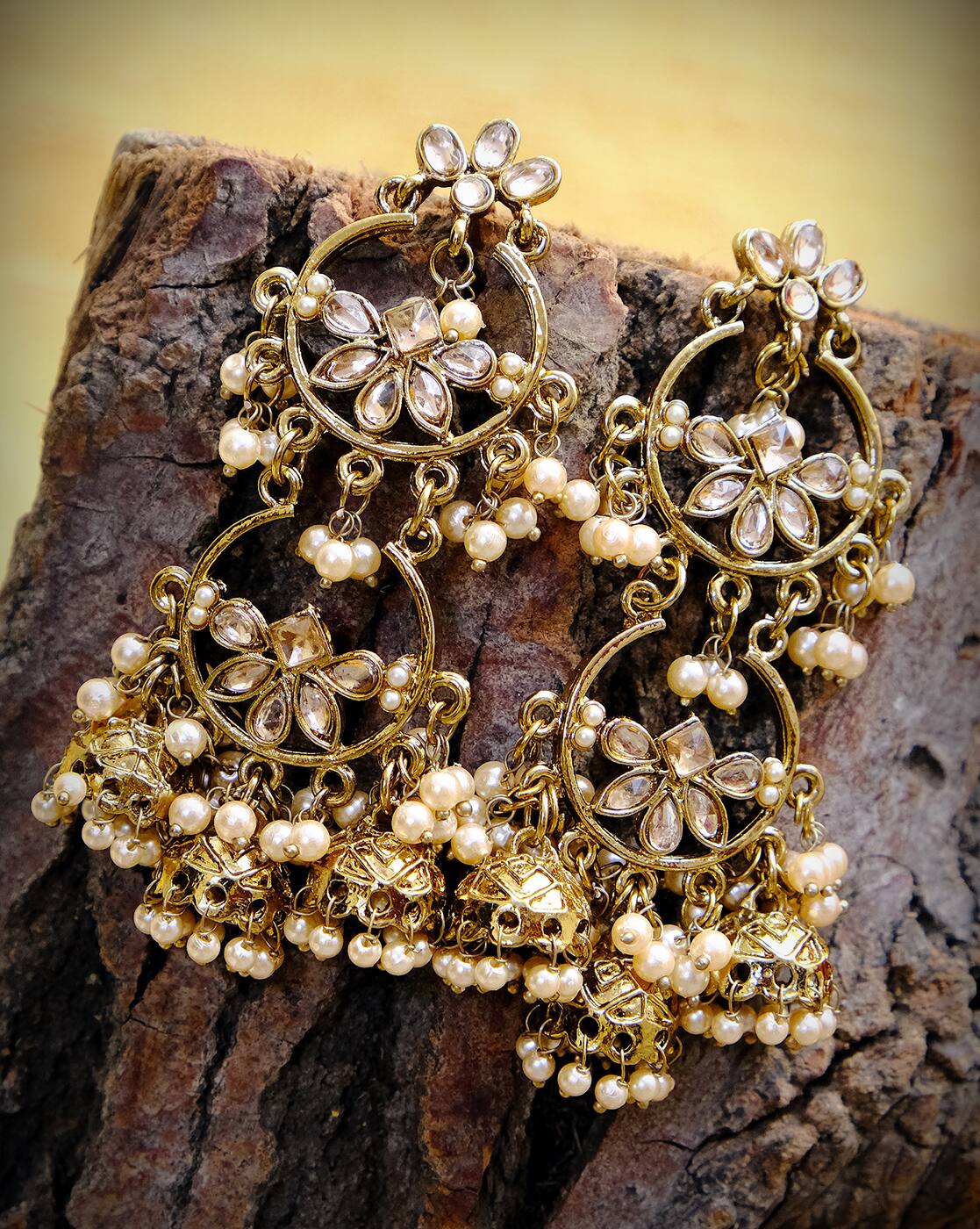 Gold-toned chandelier earrings with pearl drops and floral loops, detailed beadwork