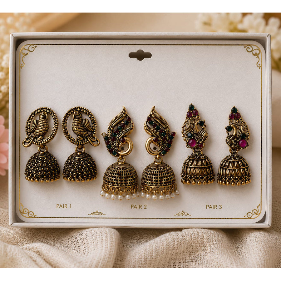 3-Pair Antique Gold Peacock Jhumka Earrings Set for Women - Set of antique gold jhumka earrings in a box, pairs with green-red stone tops