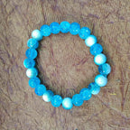 Ocean blue beaded bracelet with glossy round crystal-style beads, close-up