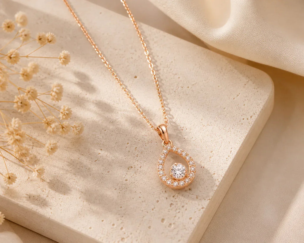 Rose gold teardrop crystal pendant necklace by Couturier Design, featuring a sleek, elegant design for women.