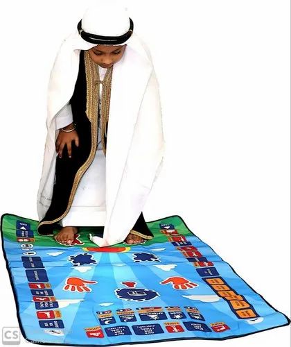 Kids prayer learning mat spread under kneeling child, blue base with prayer position blocks
