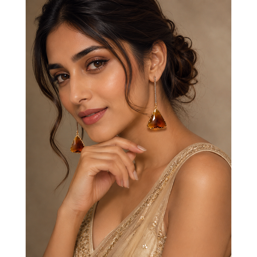 Amber Triangle Crystal Drop Earrings for Women - Gold Tone - Amber triangular drop earrings in gold tone, worn by a woman with faceted stones