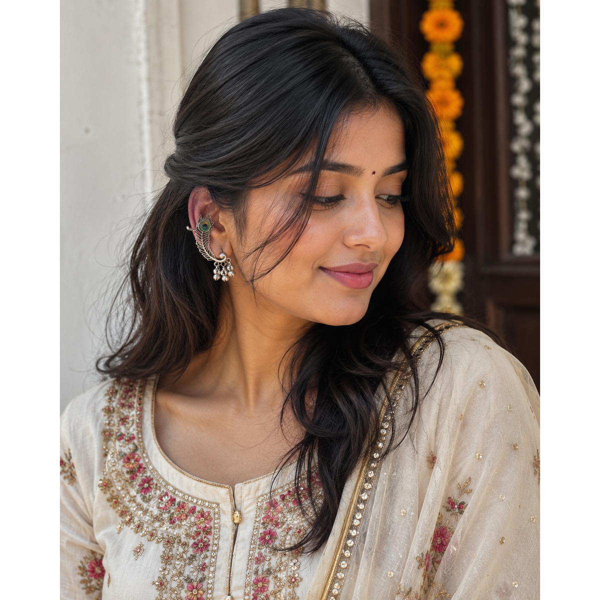Oxidized silver peacock ear cuff earrings with green-blue peacock eye detail