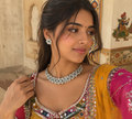 Choker necklace set with sky-blue floral stones and matching stud earrings, worn