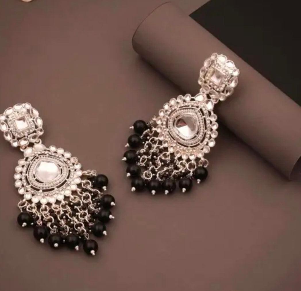 Close-up of oxidized silver Chandbali earrings with black bead drops