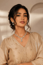Floral necklace and dangling earrings set with clear-stone accents, silver-toned