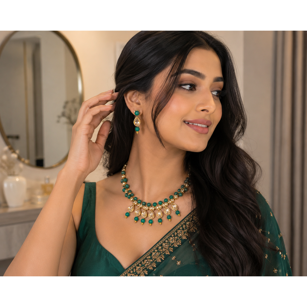 Green beaded kundan necklace with teardrop earrings on model in dark green outfit